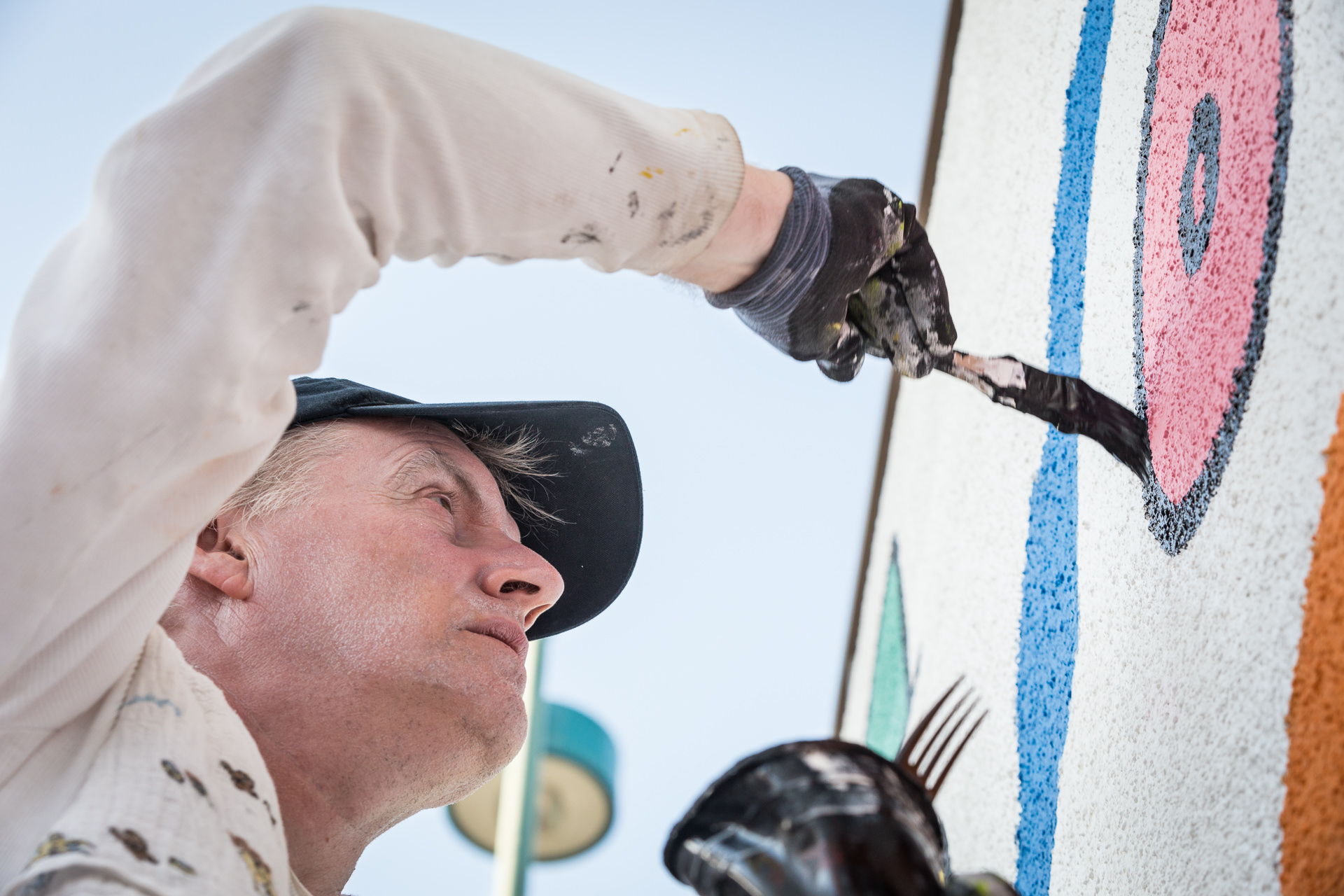 Photo of mural artist at Lofts at NoHo Commons Apartments in North Hollywood, Los Angeles.